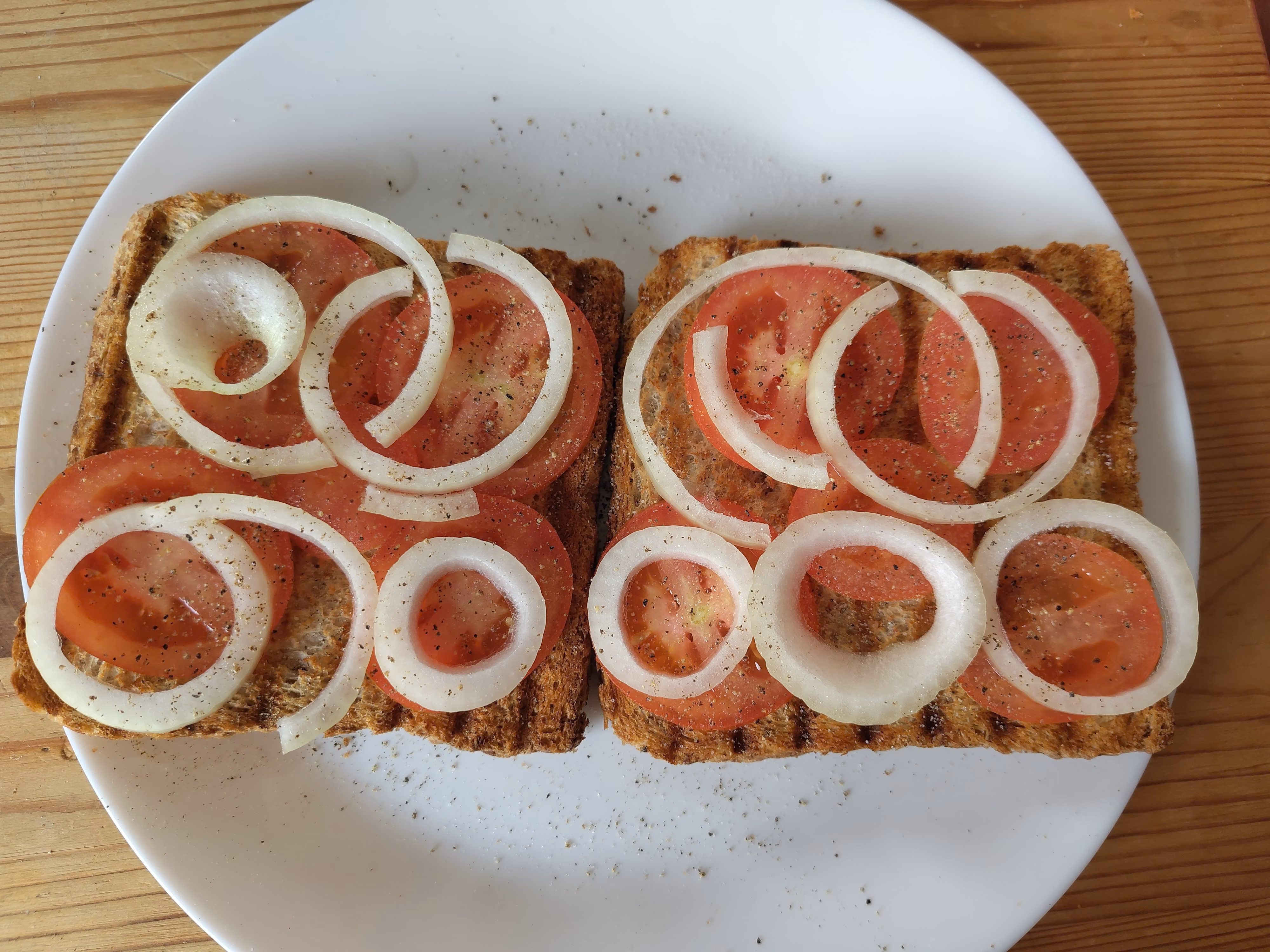 Toast with tomatoes, onions, salt, and pepper