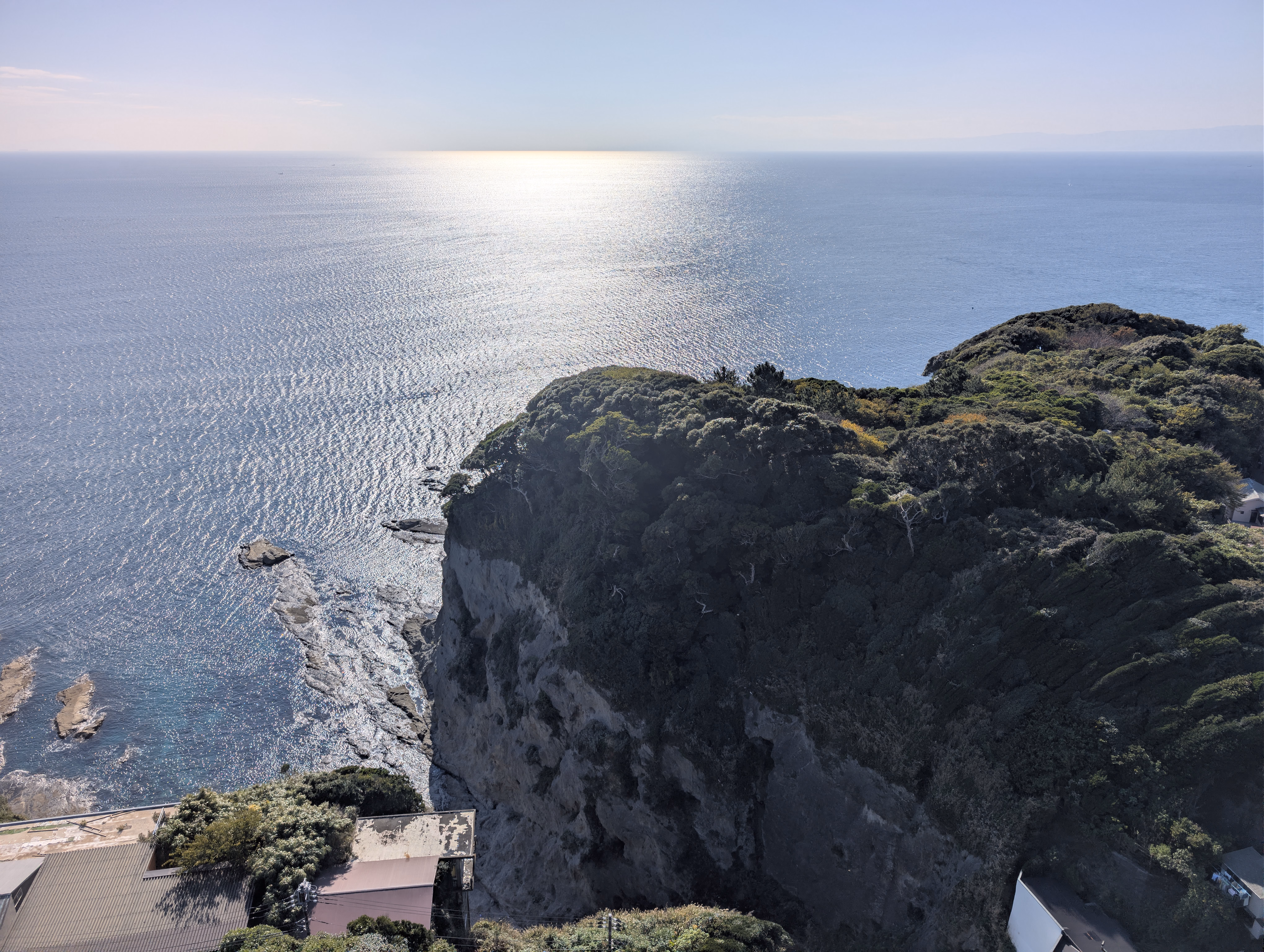 The southward view of the cliff in front of the ocean again, but this tme at very sunny weather. A part of the ocean is lit up by the sunlight.
