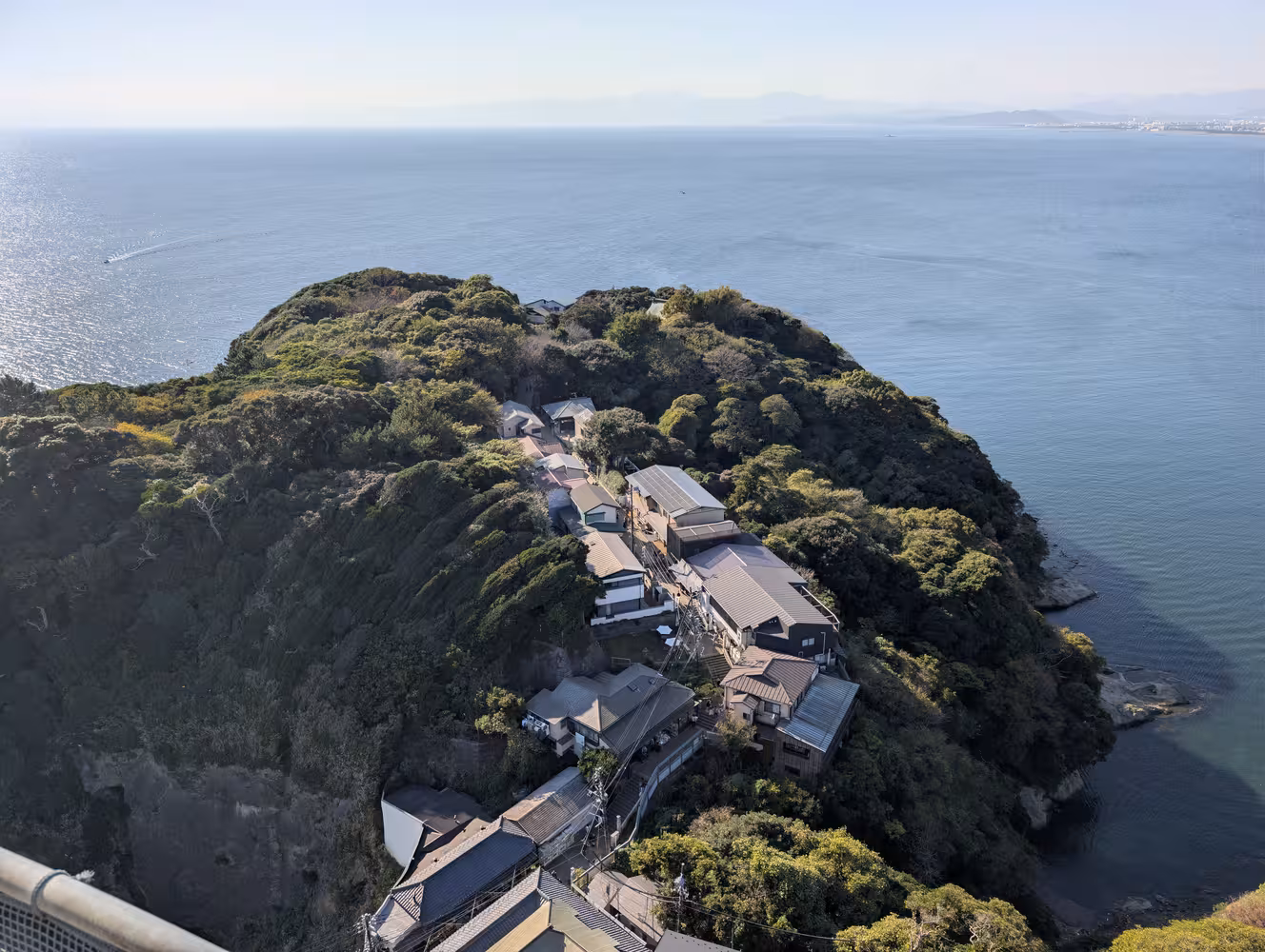 The western half of Enoshima: A narrow street surrounded by buildings on both sides leading to the end of it.