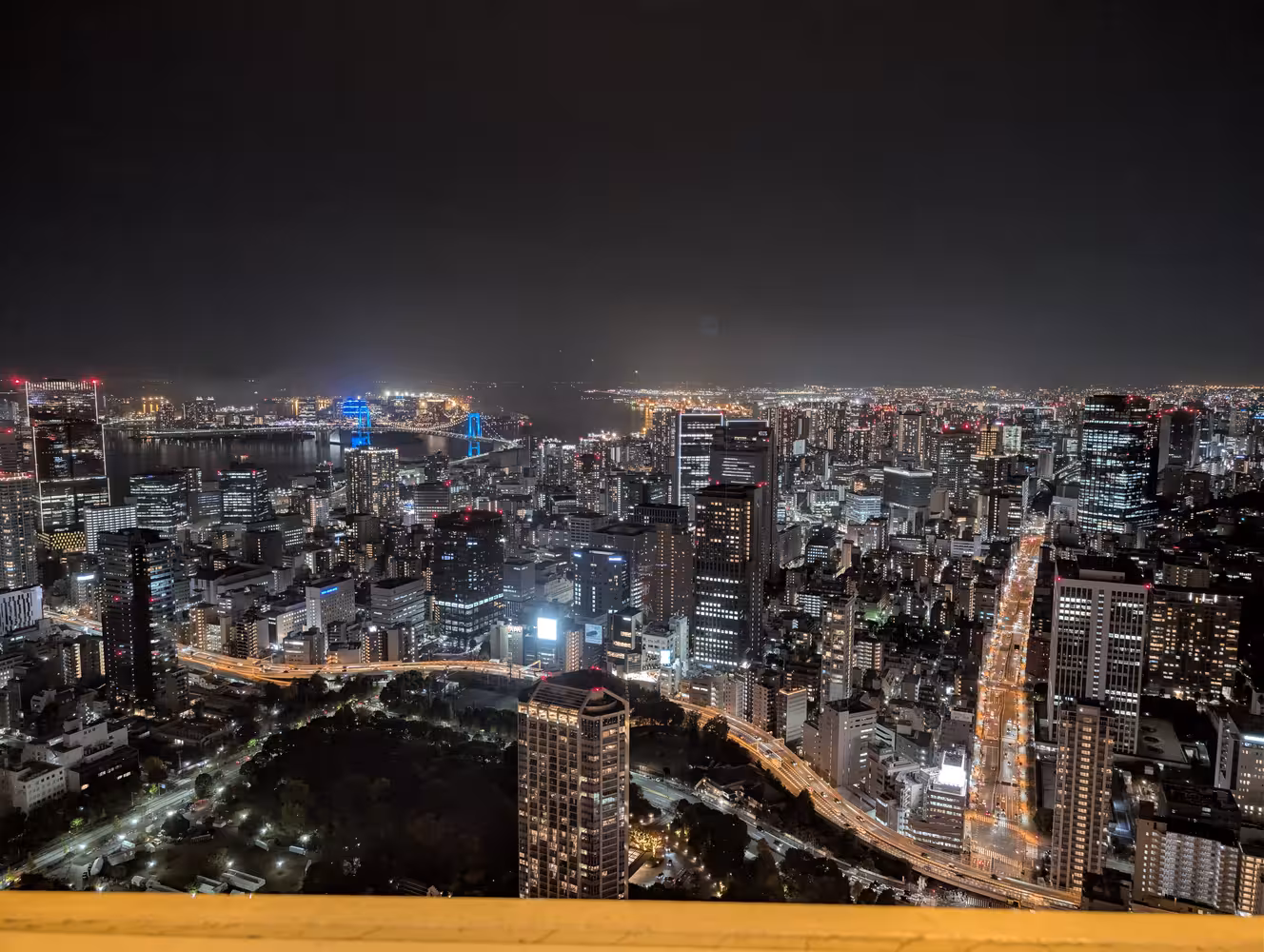 And another view. In this one a river that is crossed by a bridge that is lit in blue is visible in the left part of the shot.