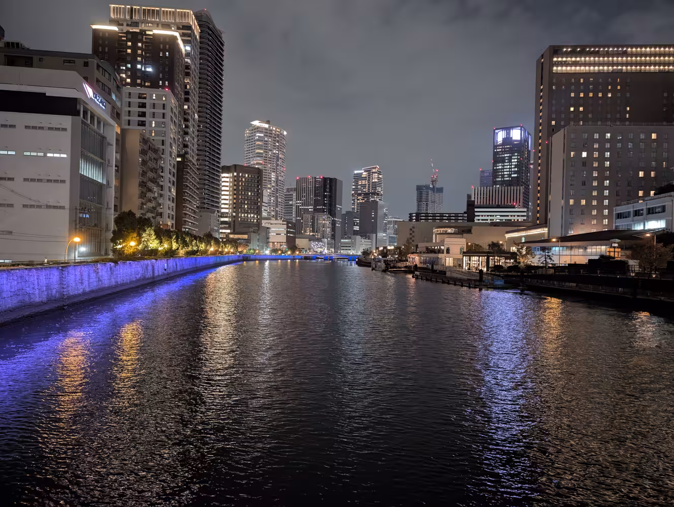A river at night, surrounded by sky-scrapers.