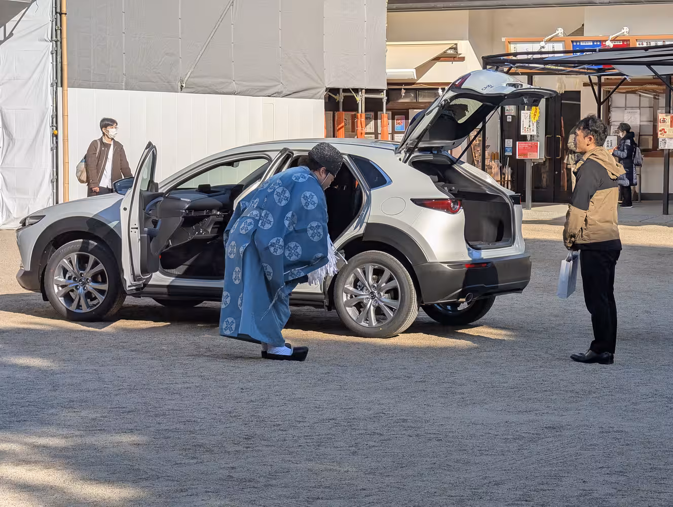 A car receiving a blessing from a Shinto priest.