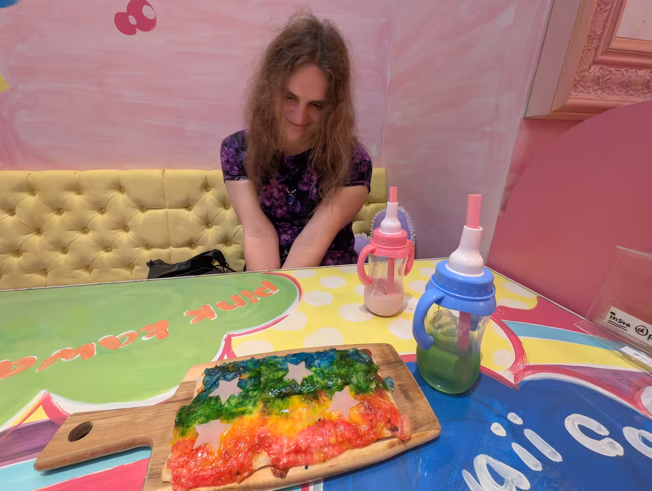 Fiona looking at the table in front of her, trying to appear cute.